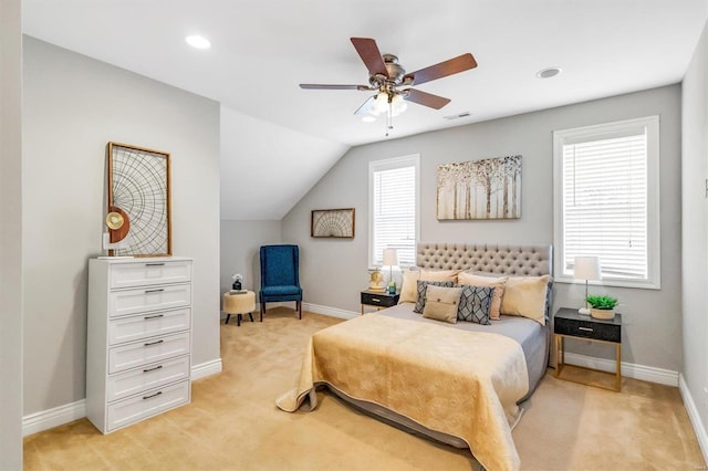 bedroom featuring baseboards, lofted ceiling, visible vents, and light colored carpet