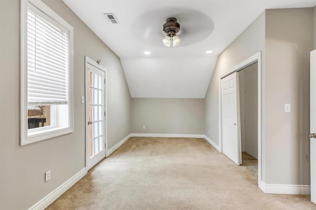 bonus room featuring baseboards, visible vents, vaulted ceiling, and carpet flooring