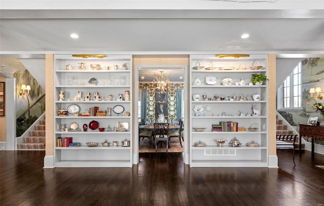 interior space with a notable chandelier and wood finished floors