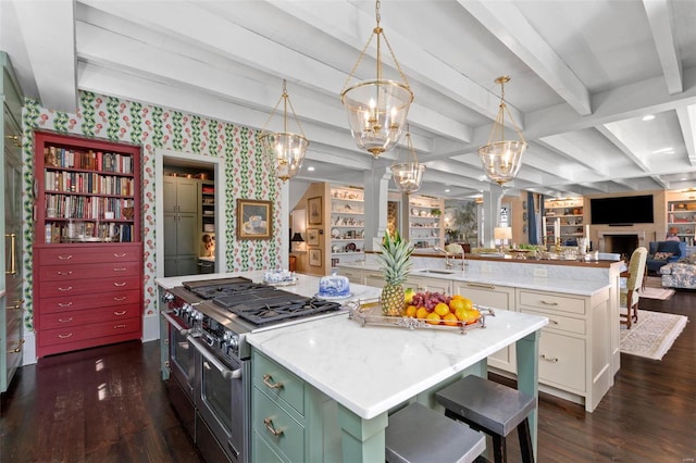 kitchen featuring open floor plan, built in features, a large island, high end stainless steel range, and dark wood-style flooring