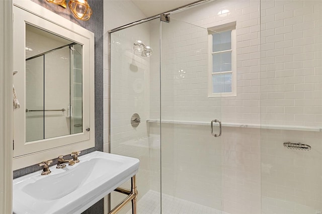 bathroom featuring a shower stall and a sink