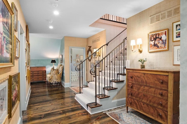 stairs featuring visible vents, wallpapered walls, baseboards, and wood finished floors