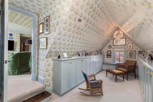 sitting room featuring visible vents, light carpet, vaulted ceiling, and wallpapered walls