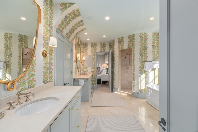 bathroom featuring wallpapered walls, two vanities, recessed lighting, tile patterned floors, and a sink