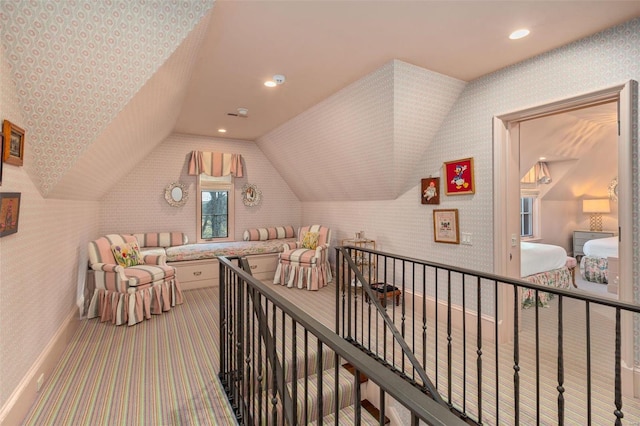 interior space featuring an upstairs landing, recessed lighting, wallpapered walls, and lofted ceiling