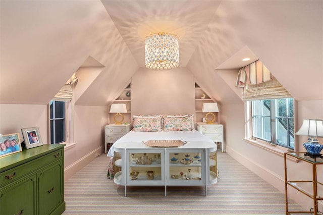 bedroom with baseboards, carpet floors, lofted ceiling, and a chandelier