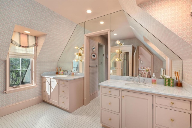 full bathroom featuring wallpapered walls, two vanities, recessed lighting, a sink, and vaulted ceiling