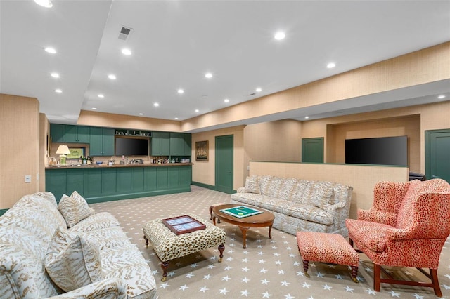 living area with recessed lighting, visible vents, and light colored carpet