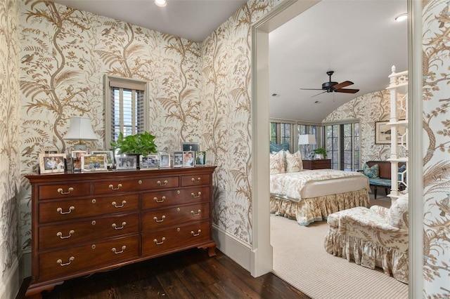 bedroom featuring recessed lighting, dark wood finished floors, vaulted ceiling, and wallpapered walls