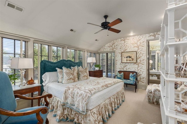 bedroom featuring visible vents, carpet flooring, vaulted ceiling, and wallpapered walls