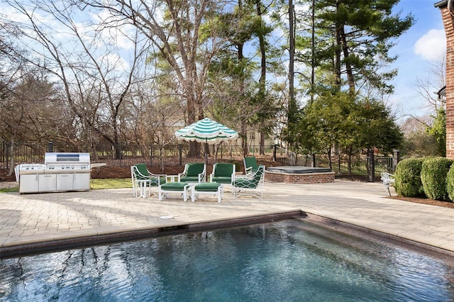 view of pool featuring a patio, a jacuzzi, fence, and a fenced in pool