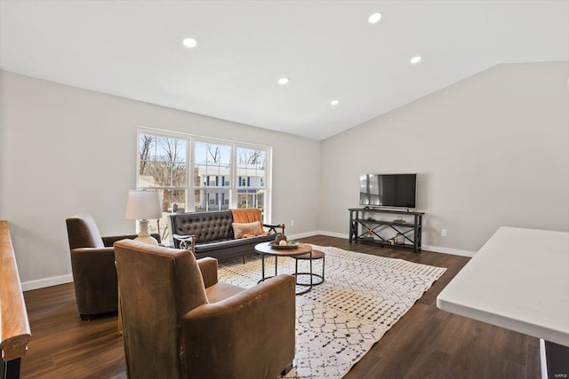 living area featuring lofted ceiling, baseboards, and dark wood-type flooring