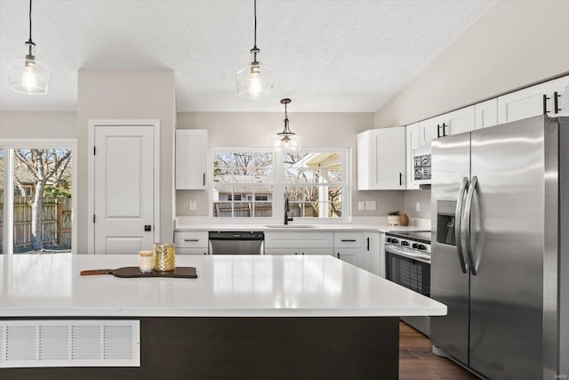 kitchen featuring a sink, visible vents, white cabinets, light countertops, and appliances with stainless steel finishes