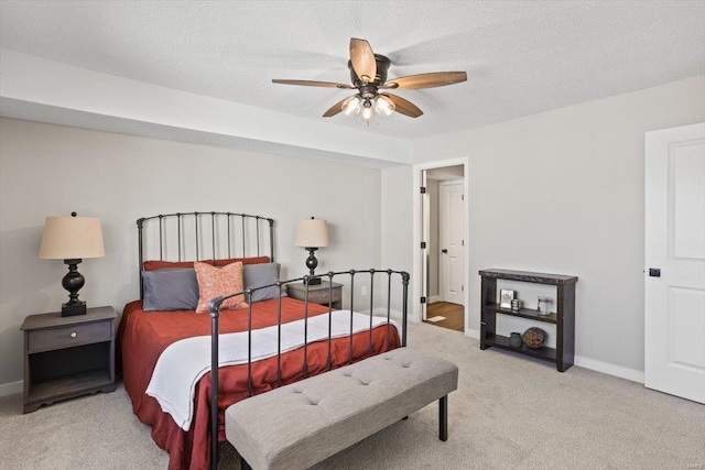 bedroom featuring a textured ceiling, carpet, a ceiling fan, and baseboards