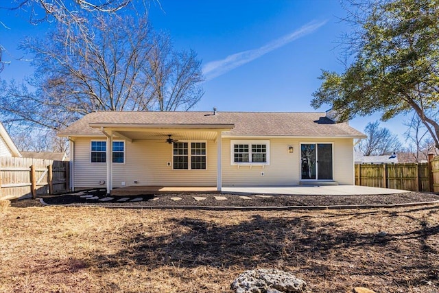 back of property with a patio area, fence, and a ceiling fan