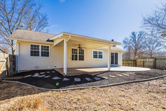 rear view of property with ceiling fan, a patio area, and a fenced backyard