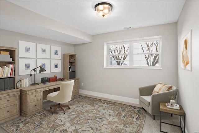 office featuring visible vents, baseboards, and a textured ceiling