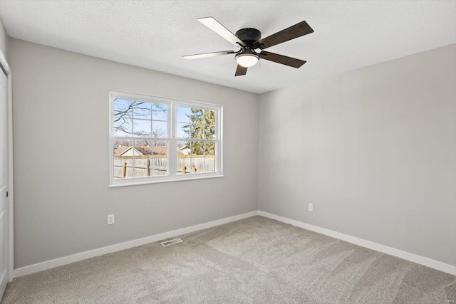 unfurnished bedroom with carpet floors, baseboards, visible vents, and a textured ceiling