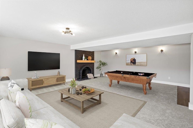 carpeted living area featuring a fireplace, baseboards, and a textured ceiling