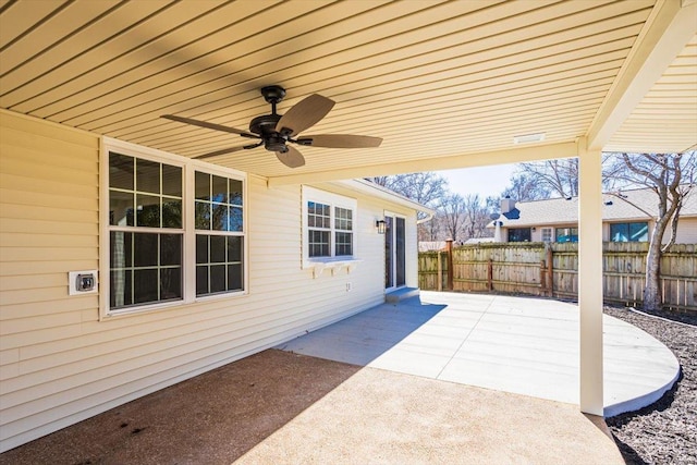 view of patio featuring ceiling fan and fence