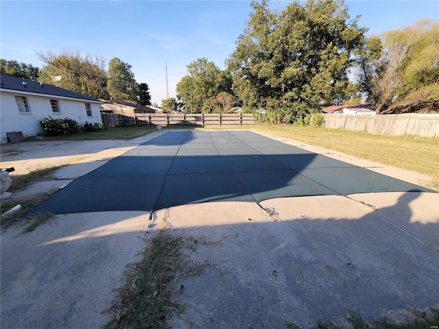 view of pool featuring a patio area, a fenced backyard, and a yard