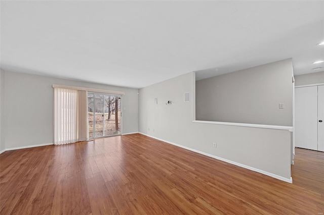 spare room with wood finished floors and baseboards