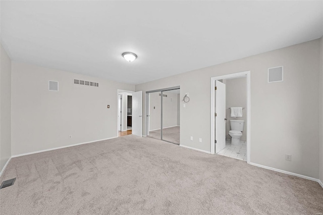 unfurnished bedroom featuring carpet floors, visible vents, and baseboards