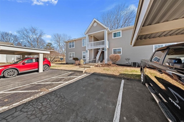 partially covered parking lot featuring stairway