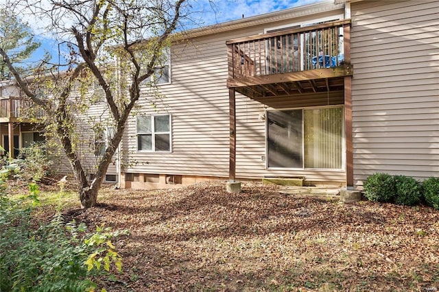 view of property exterior with a wooden deck