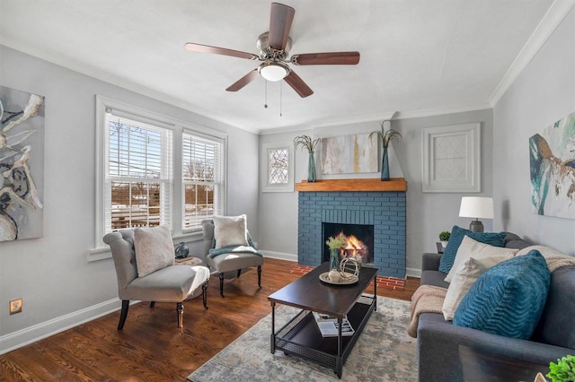 living area featuring ornamental molding, a brick fireplace, dark wood finished floors, and baseboards