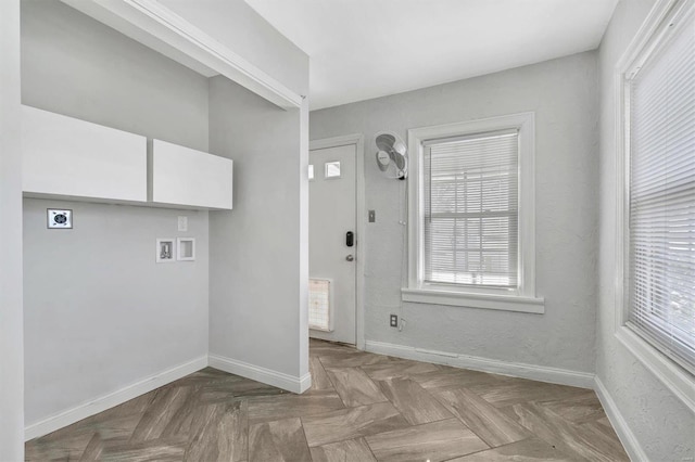 laundry area featuring laundry area, baseboards, hookup for a washing machine, hookup for an electric dryer, and a wealth of natural light