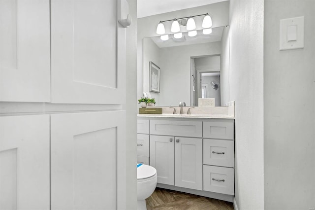 bathroom with toilet and vanity