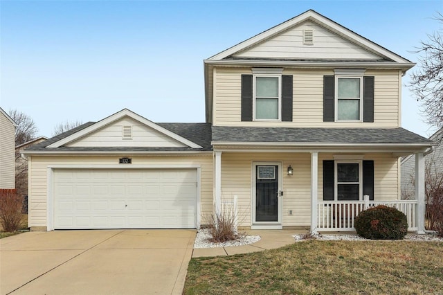 traditional home featuring a shingled roof, covered porch, an attached garage, and concrete driveway