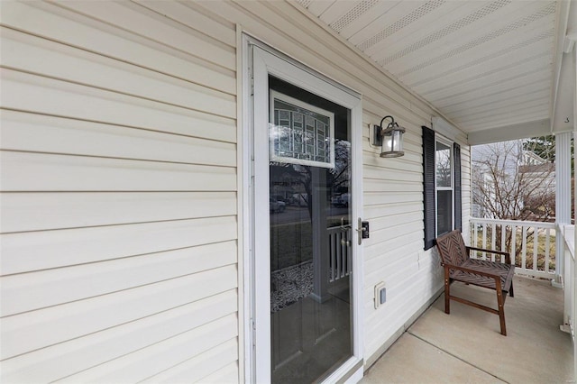 view of exterior entry featuring a porch