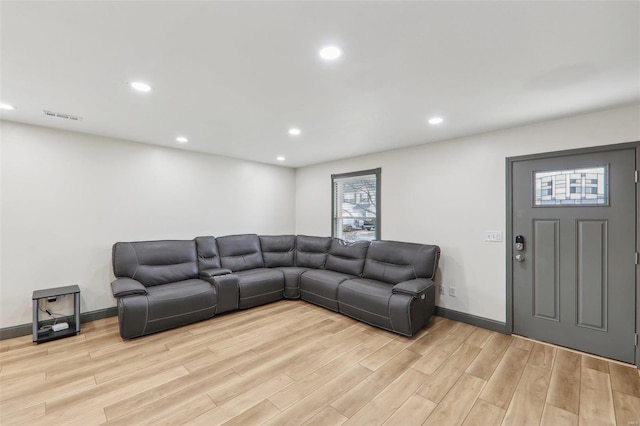 living area with baseboards, light wood finished floors, visible vents, and recessed lighting