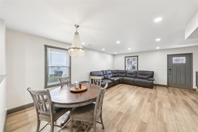 dining space featuring recessed lighting, light wood-style flooring, baseboards, and an inviting chandelier