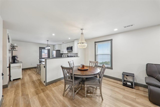 dining area featuring light wood-style flooring, visible vents, baseboards, and recessed lighting