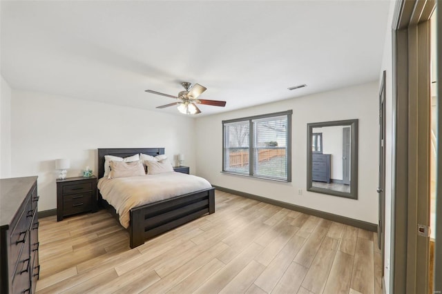 bedroom with visible vents, light wood-style flooring, and baseboards