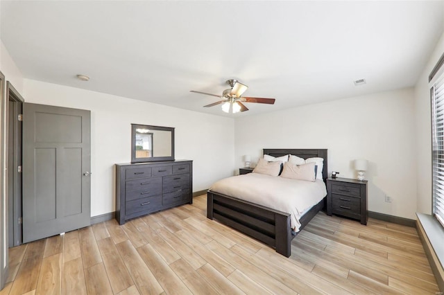 bedroom featuring baseboards, visible vents, and light wood-style floors