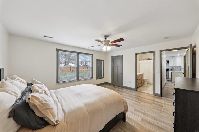 bedroom with visible vents, ensuite bathroom, light wood-style floors, ceiling fan, and baseboards