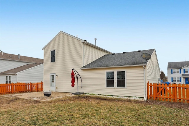 back of property with a fenced backyard, a lawn, and a patio