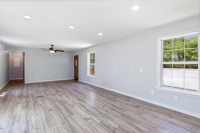 empty room featuring light wood-style floors, recessed lighting, a ceiling fan, and baseboards