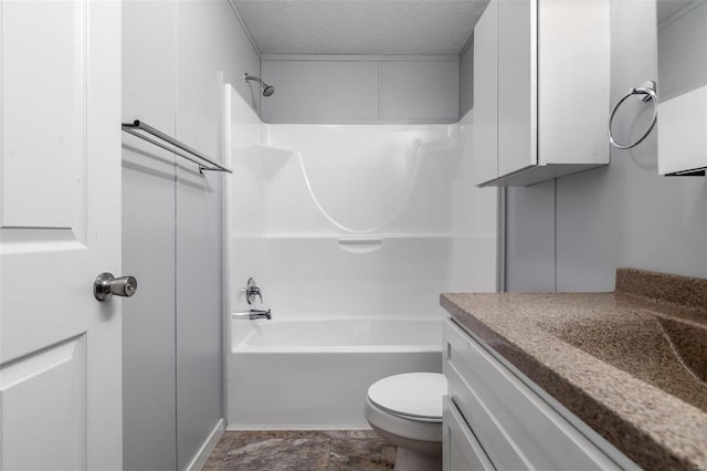 bathroom featuring a textured ceiling, toilet, shower / bathtub combination, and vanity