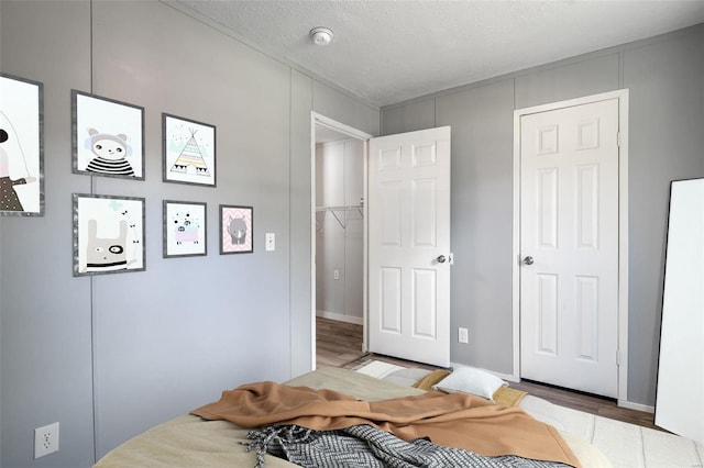 bedroom featuring a textured ceiling and wood finished floors