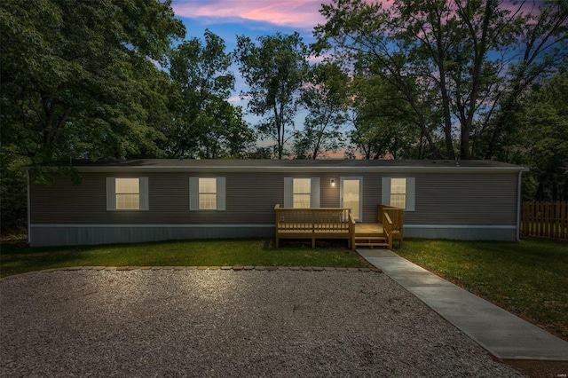 manufactured / mobile home with a front lawn and a deck