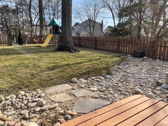 view of yard featuring a playground and fence