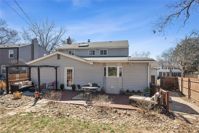 rear view of house featuring a wooden deck, a fenced backyard, outdoor lounge area, and a pergola