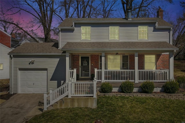 traditional-style house with brick siding, covered porch, an attached garage, and a chimney