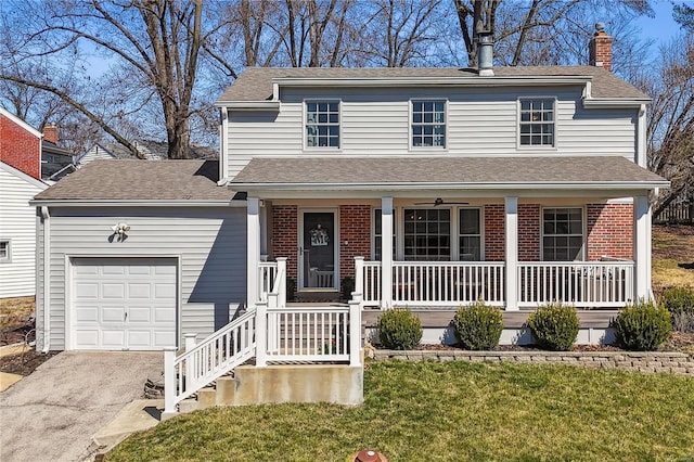 traditional home featuring a front yard, covered porch, a chimney, a garage, and brick siding