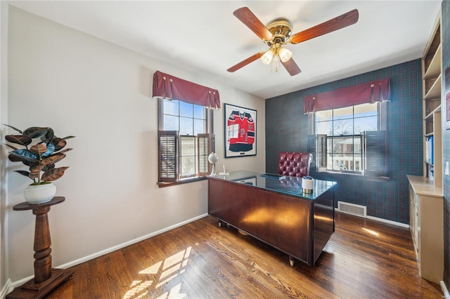 home office featuring visible vents, baseboards, wood finished floors, and a ceiling fan